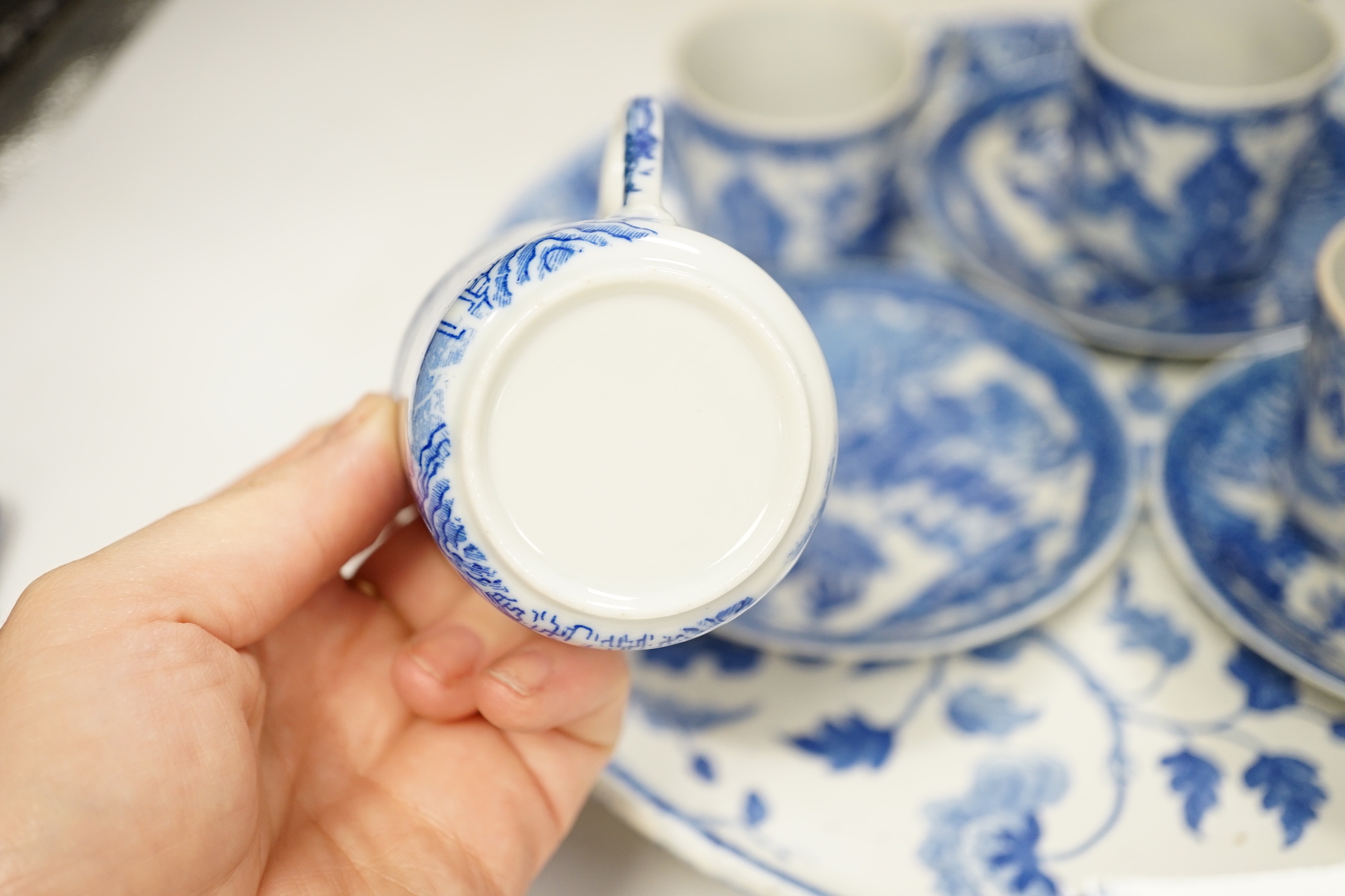 A Japanese blue and white pot coffee set and a 19th century blue and white cheese dish and a Chinese green glass and pewter mounted mug
